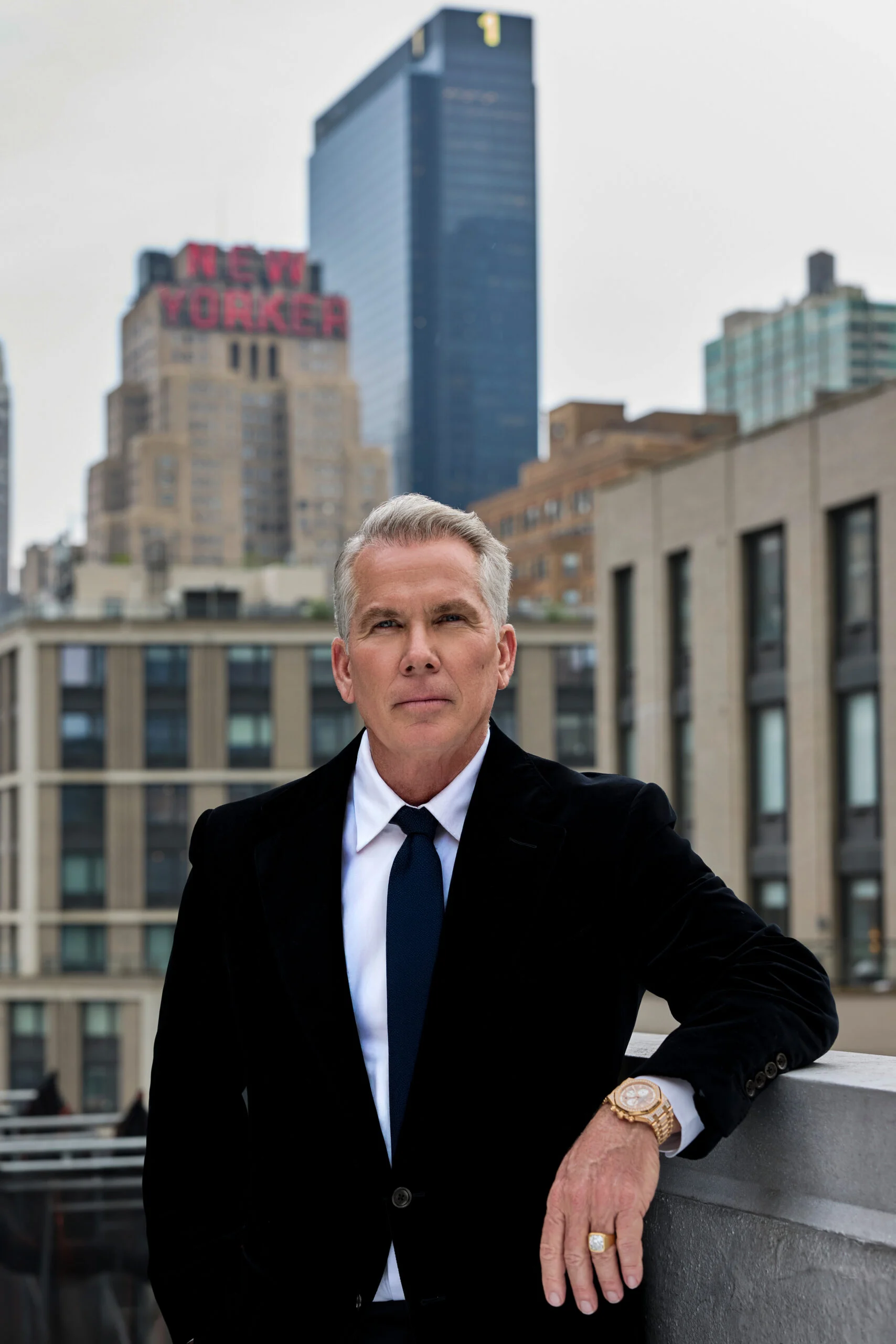 A man in a suit jacket looking sideways.